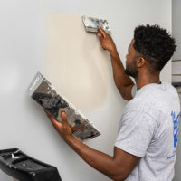 The Patch Boys drywall repair franchise employee working on a wall